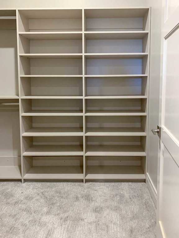 built-in shelves with several levels in a spacious walk-in closet