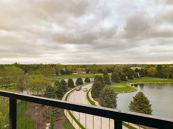 a view from the private balcony overlooking the golf course and Wilderness Woods Plaza