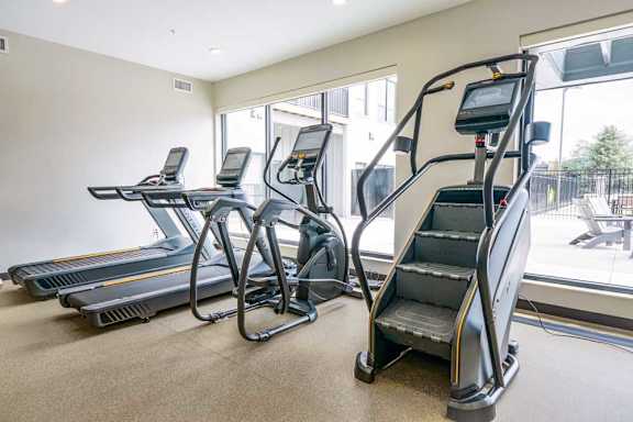a 24-hour fitness center with treadmills, ellipticals, and a Stairmaster