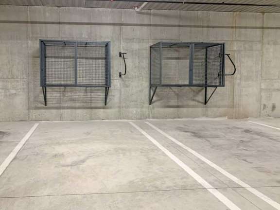 an underground climate-controlled parking garage with wall-mounted storage
