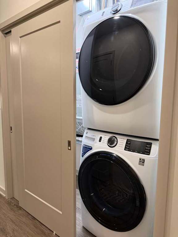 In-unit stacked washer and dryer in a closet with sliding door.