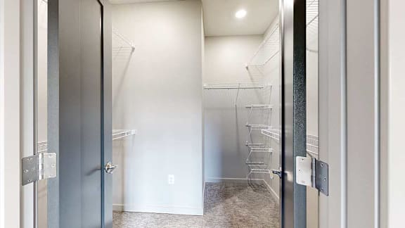 a walk-in closet with built-in shelving and hanging space