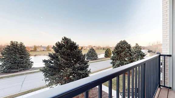 a balcony overlooks a pond at the neighboring Wilderness Ridge
