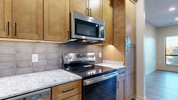 a kitchen with a stove top oven and microwave above it