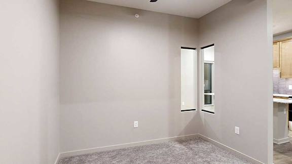 a room with a carpeted floor and a window
