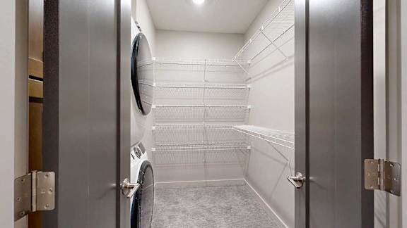 a walk-in closet with a laundry