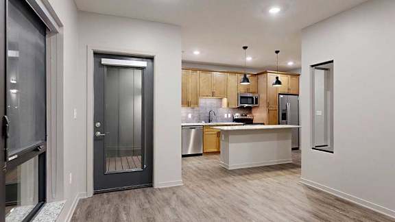 A kitchen with a white countertop and wooden cabinets.