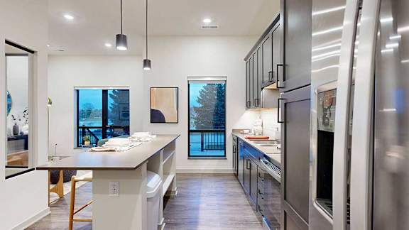 a modern kitchen with white quartz countertops and overhead cabinets