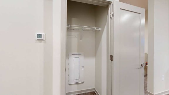 a coat closet in the main entryway of the guest suite
