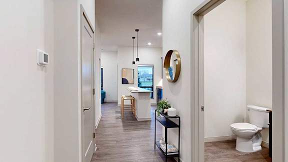 a hallway view leading to the kitchen and bathroom
