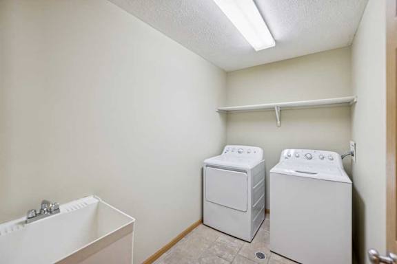 A small laundry room with a washer and dryer.