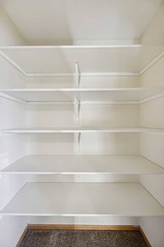 Empty white shelves in a room.