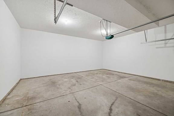 A room with a white wall and a concrete floor.