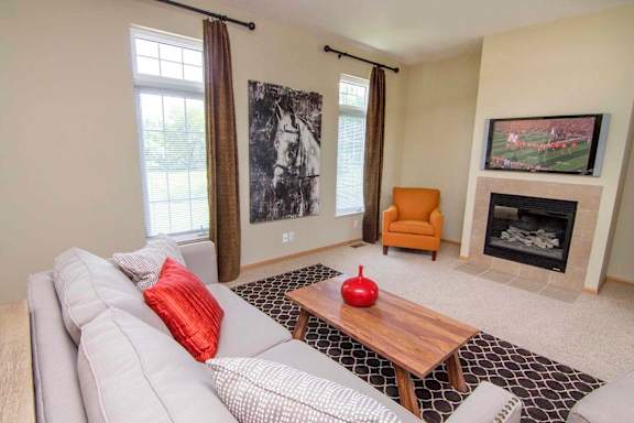 a living room with a white couch and a fireplace