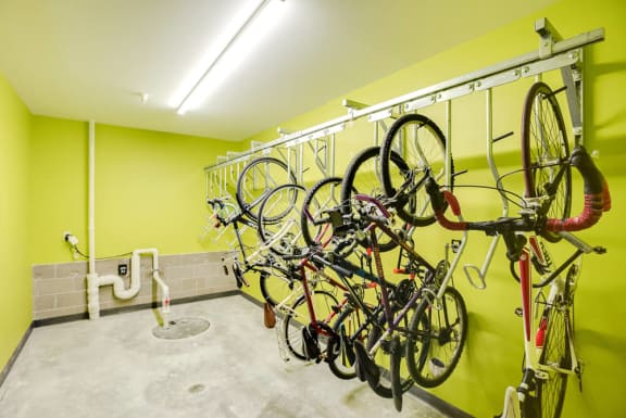 a room with a rack of bikes hanging on the wall