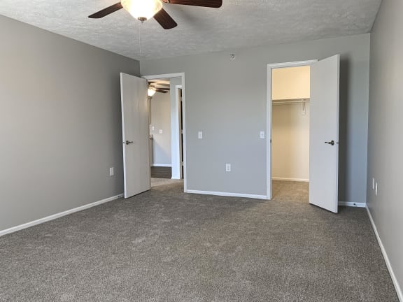 Carpeted bedroom with walk in closet at Eagle Run Apartments in Omaha Nebraska