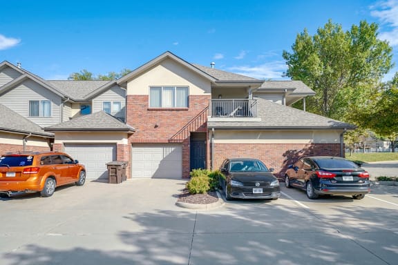 a two-story villa with brick exterior and attached garages