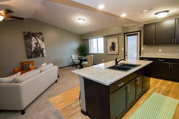 A kitchen with a white sofa and a countertop.