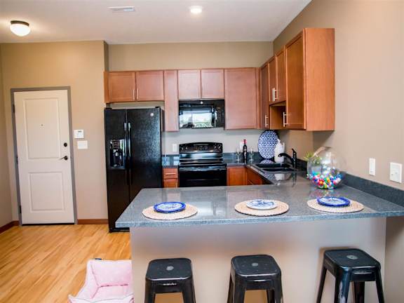 U-shaped kitchen with black appliances