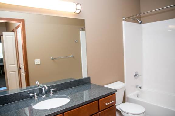 A bathroom with a sink, toilet, and bathtub.
