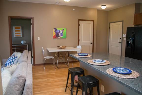 A dining area with a white table and chairs.