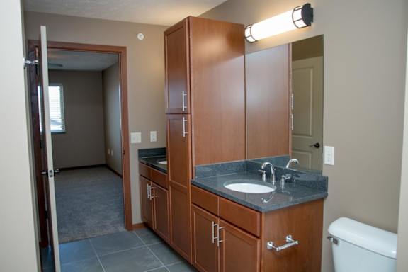 A bathroom with a sink, toilet, and medicine cabinet.