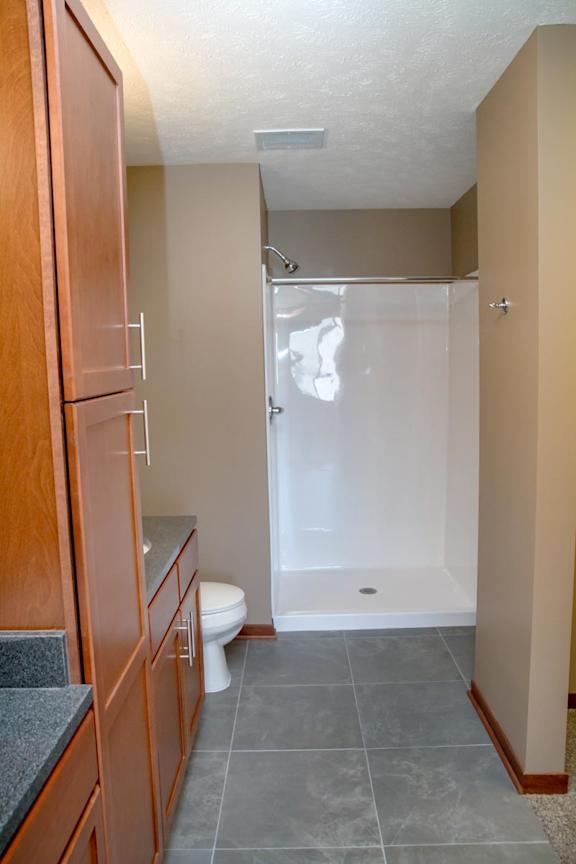 A bathroom with a walk-in shower and a toilet.