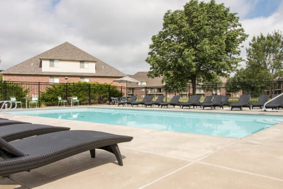Pool with lounge chairs at Fountain Glen Apartments!