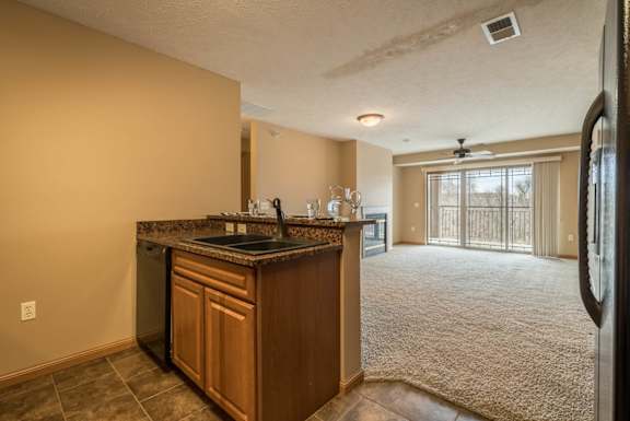 a kitchen looking into carpeted living room