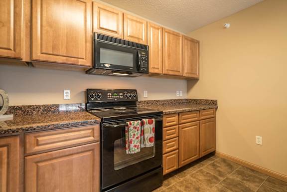 a kitchen with a stove and a microwave
