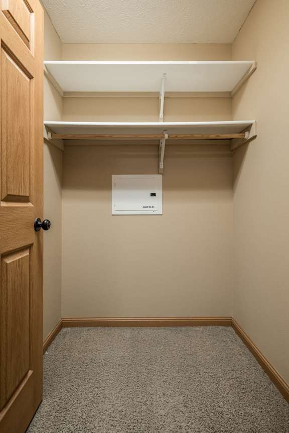 a empty closet with a door and a paper towel dispenser