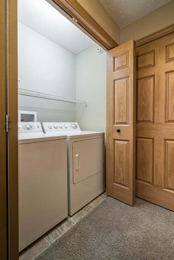 a washer and dryer in a laundry room with a door