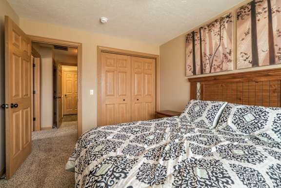 a bedroom with a bed and a closet