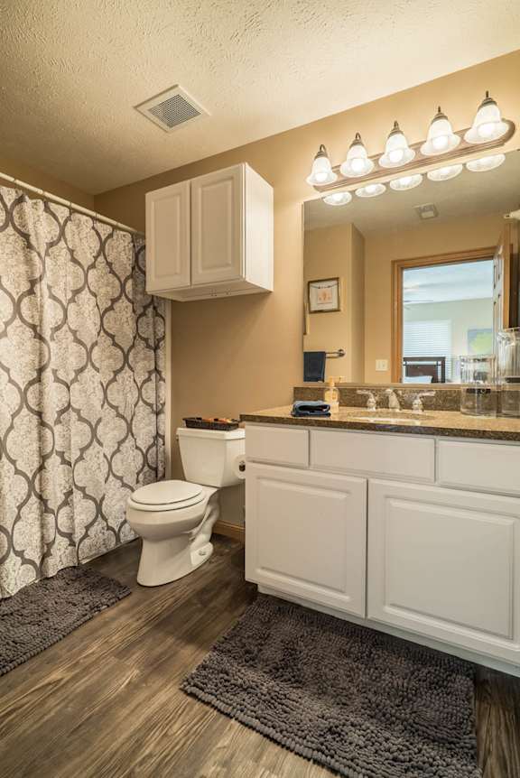 a bathroom with a toilet and a sink and a mirror