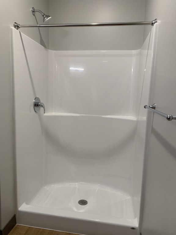 Built in walk in shower in studio bathroom at Haven at Uptown