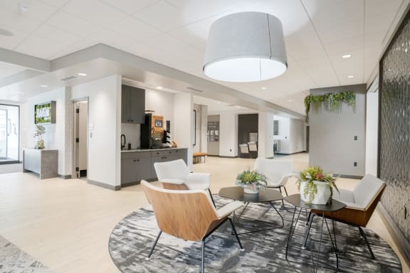 a living room with chairs and a table