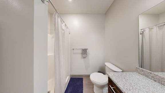 a bathroom with a toilet sink and shower