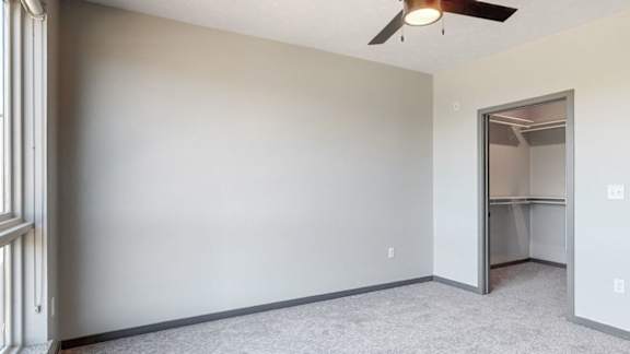 Bedroom with attached walk in closet in the Melody floor plan at Haven at Uptown in Lincoln, NE