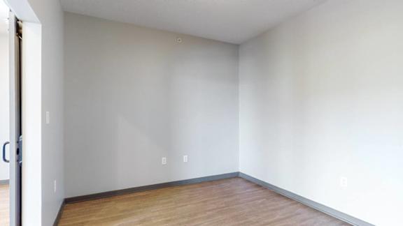 Office space off of the living-dining space that is separated by sliding barn doors at Haven at Uptown in Lincoln, NE