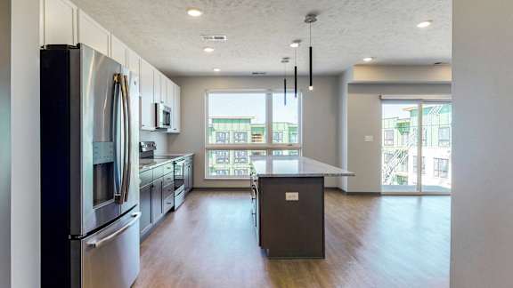 Spacious kitchen completed in the dual tone slate finish, including large windows that provide natural light directly to the kitchen in the Melody floor plan at Haven at Uptown in Lincoln, NE