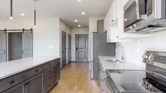 Spacious kitchen completed in the dual tone slate finish in the Melody floor plan at Haven at Uptown in Lincoln, NE