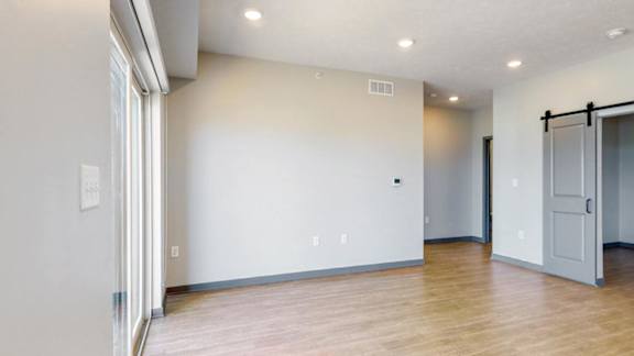Living space with natural light comin from the attached balcony are in the Melody floor plan at Haven at Uptown in Lincoln, NE