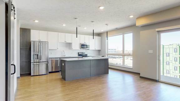 Living space connected to the kitchen in an open concept Melody floor plan at Haven at Uptown in Lincoln, NE
