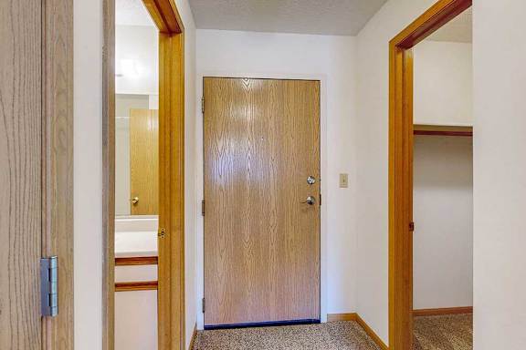 The front door with the bathroom to the left and the closet to the right