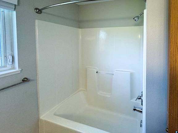 a bathroom with a bathtub shower