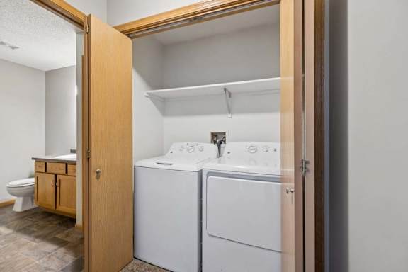 A small laundry room with a washer and dryer.