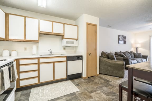 Kitchen with updated flooring and white and wood cabinetry