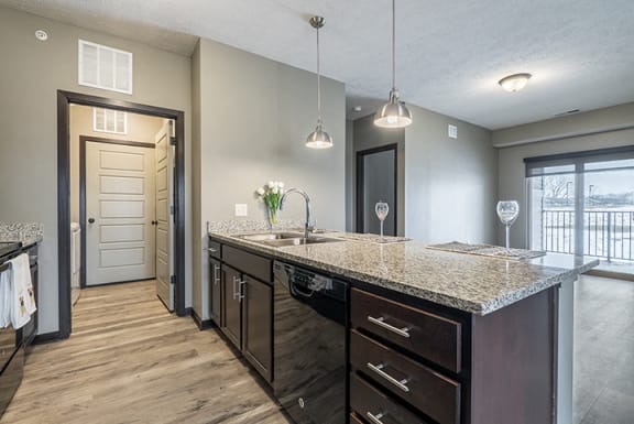 Kitchen with granite counters and island at North Pointe Villas