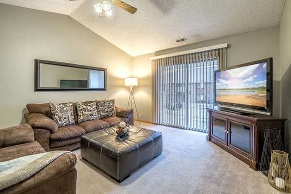 Living room with large sliding doors at Fountain Glen Apartments