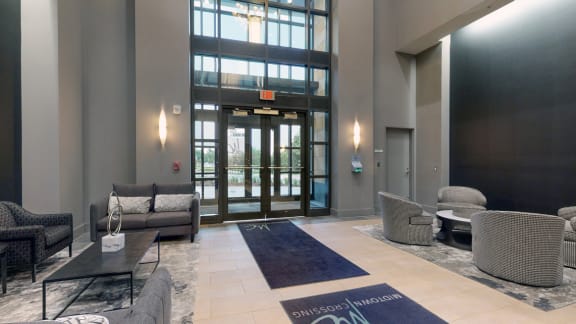 Lobby at Midtown Crossing Apartments in Omaha Nebraska featuring plenty of seating and a coffee station